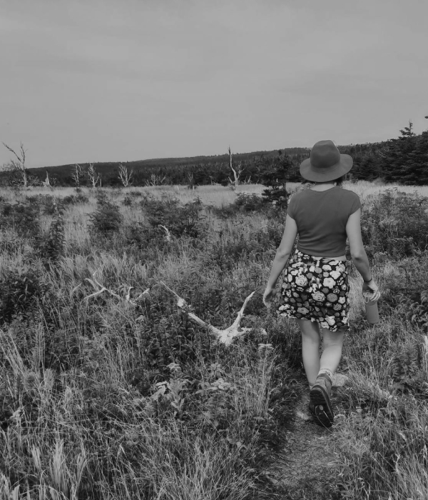 Young woman walking in a field